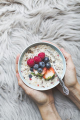 Bowl with cereals porridge in hands