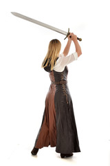 full length portrait of girl wearing brown  fantasy costume.. standing pose with back to the camera...