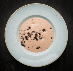Top view of plate chestnut cream soup with black truffle