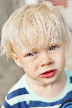 Portrait of young blond boy looking at camera