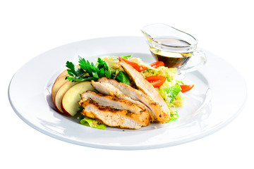 Roasted juicy pork steak with apples and soy sauce in a white plate isolated on white background