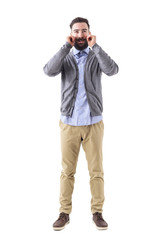 Smiling bearded hipster twirling mustache wearing smart casual clothes. Full body length portrait isolated on white studio background. 