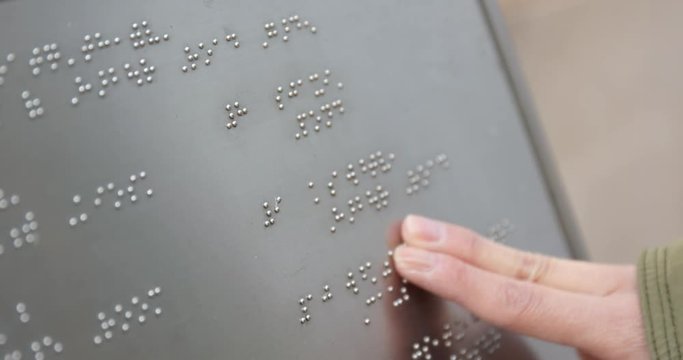 Blind reading on Braille at outdoor