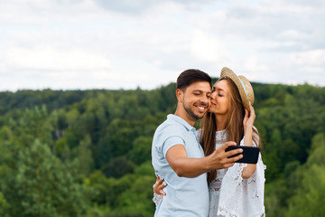Romantic. Happy Couple In Love Taking Photos On Phone In Nature
