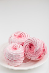 Obraz na płótnie Canvas Homemade pink zephyr or marshmallow isolated on white