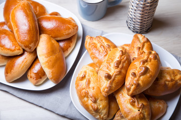 Traditional Russian baked pies (pirozhki). Close-up, selective focus.