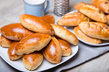 Traditional Russian baked pies (pirozhki). Close-up, selective focus.