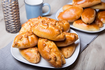 Traditional Russian baked pies (pirozhki). Close-up, selective focus.