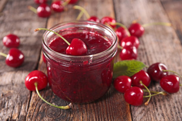 cherry jam on wood background