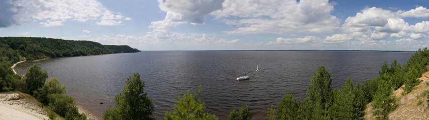 The panorama of the bay in which the sailing yacht is anchored. Sunny day. Dnipro river. Ukraine