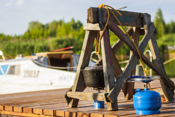 Cooking at the yacht club at the pier with the help of a boiler and a gas 