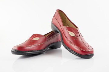 Female red leather shoe on white background, isolated product, footwear.