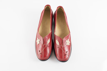 Female red leather shoe on white background, isolated product, footwear.