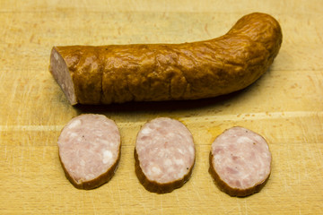 Three slices of sausage cut.