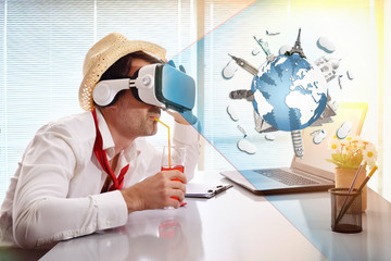 Man working imagining his vacation with vr glasses representation drinking