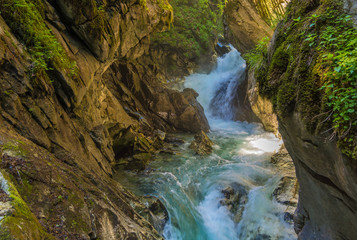 Obraz premium Waterfalls Stanghe (Gilfenklamm) localed near Racines, Bolzano in South Tyrol, Italy. Wooden bridges and runways lead through the canyon and give a spectacular sight to the waterfalls.