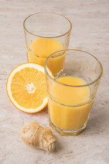 high angle view of homemade orange juice and ginger on marble table