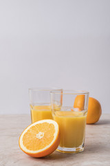 homemade orange juice and oranges on marble table