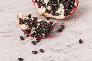 ripe appetizing pomegranate on marble tabletop