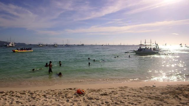 Jukung Boats & Locals Swimming; White Beach; Boracay, Philippines