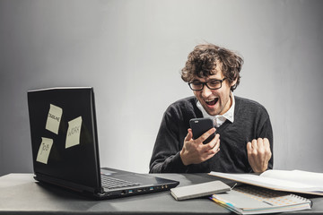 Excited man looking at his phone