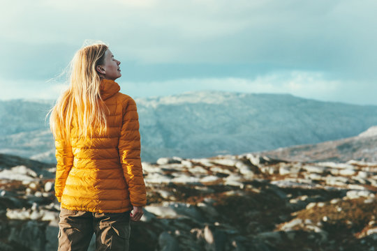 Traveler Woman outdoor mountaineering Travel healthy Lifestyle concept blonde girl adventurer enjoying scandinavian mountains landscape