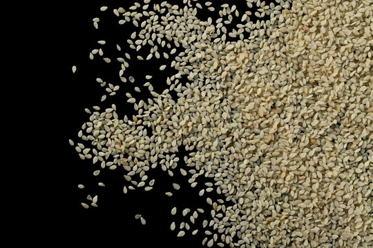 Sesame seeds pile isolated on black background, with clipping path