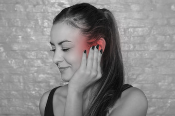 Fototapeta premium young woman struggles with ear drumache