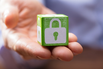 Hand Holding Green Block With Lock Symbol