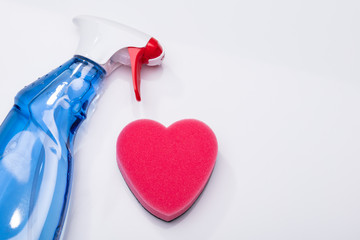 Heart Shape Sponge And Cleaning Spray Bottle On White Background