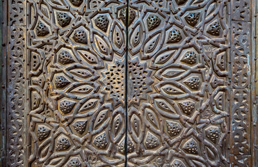 Ornaments of the bronze-plate ornate door of minbar of Al Sultan Hasan Mosque, historic public mosque located in Cairo, Egypt