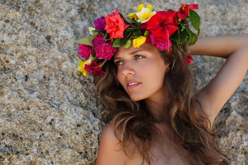 Beautiful girl with long hair and flower wreath on her head