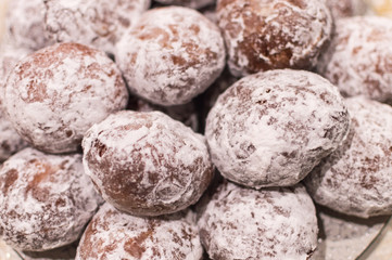 Fototapeta na wymiar Fresh baked homemade donuts with powdered sugar on them - close up