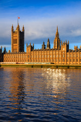 Fototapeta na wymiar Palace of Westminster windows reflecting in River Thames London UK