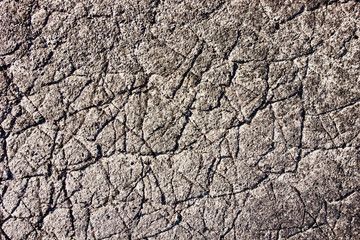 Gray cracked asphalt texture pattern.