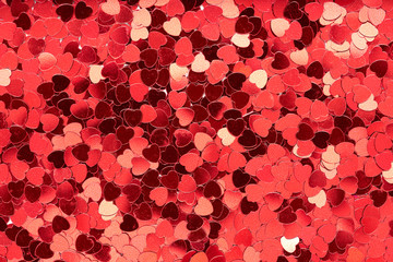 Aerial, top view of red heart shape glitter background