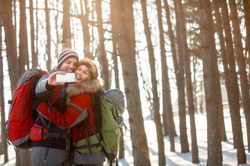 Couple in love makes selfie on mountain