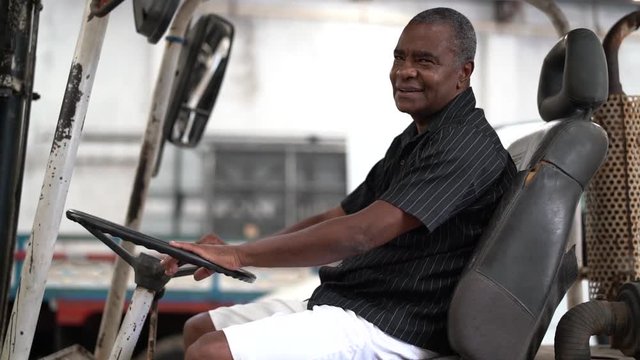 Portrait of a Industrial Worker Driving Forklift