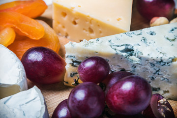 different types of cheese with nuts and fruit