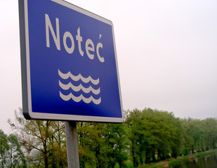 Noteć river and river information blue sign