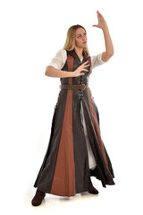 Naklejka premium full length portrait of girl wearing brown fantasy costume. standing pose on white studio background. 