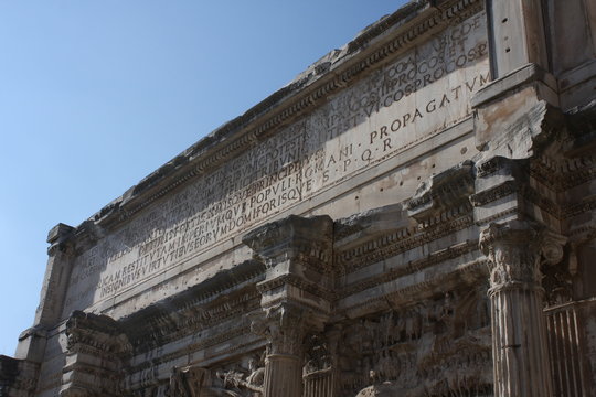 Septimius Severus Arch Roman Forum Rome Italy. Stone arch was erected in 203 AD in honor of Emperor Septimius Severus, who reigned from 193-211 AD. Panels celebrate victories in Parthia and Arabia.
