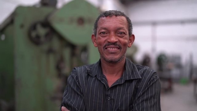 Portrait of Worker on Factory on background