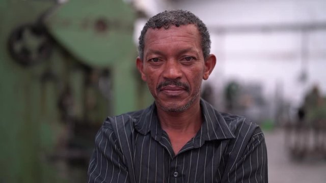 Portrait of Worker on Factory on background