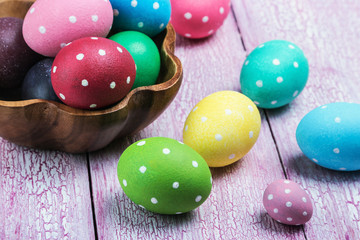 Obraz na płótnie Canvas different color Easter eggs on a wooden table. Decorations for Easter