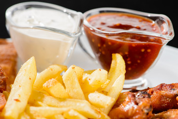 Food background with delicious fried potato and sauces, close-up