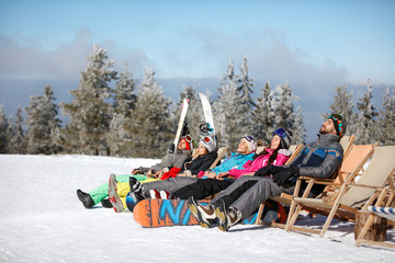 Skiers sunbathing in sunbed