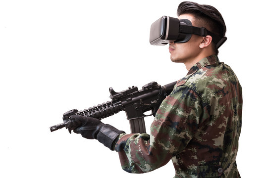 The isolated image of the soldier use a VR glasses for combat simulation training and the white backdrop. the concept of virtual hologram, simulation, gaming, internet of things and future life.