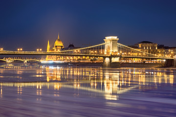 Fototapeta na wymiar Szechenyi chain bridge reflected in Danube river water with floating ice trails, Budapest