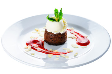 Delicious chocolate muffin with ice-cream, jam and mint on the plate